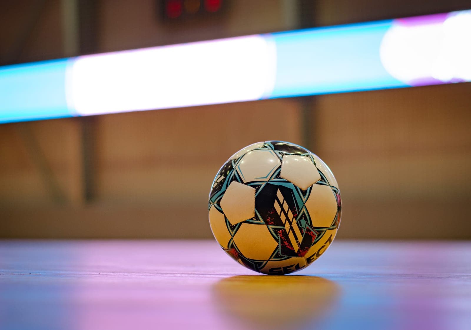 An indoor soccer ball on a court floor