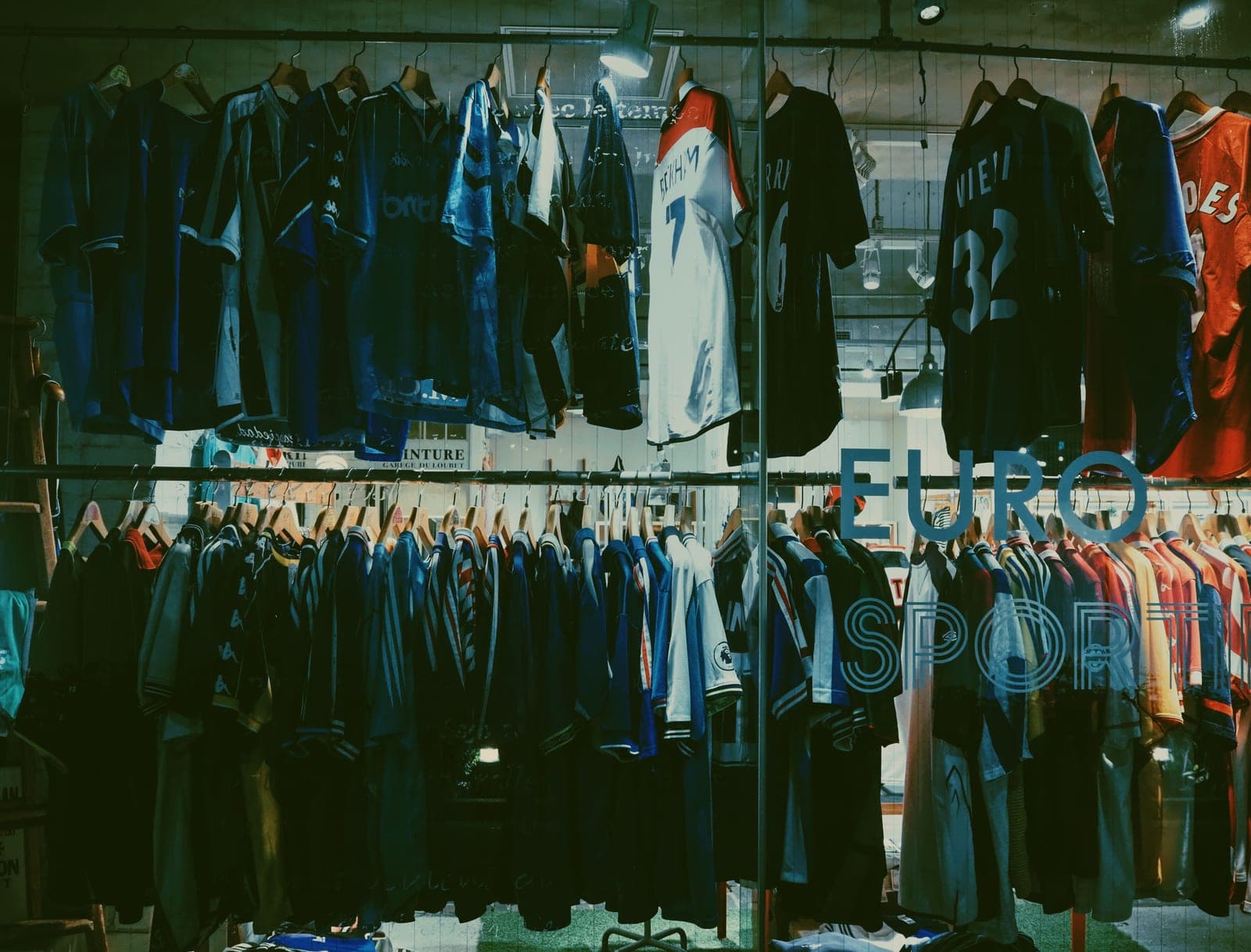 A youth soccer jersey hanging on a rail