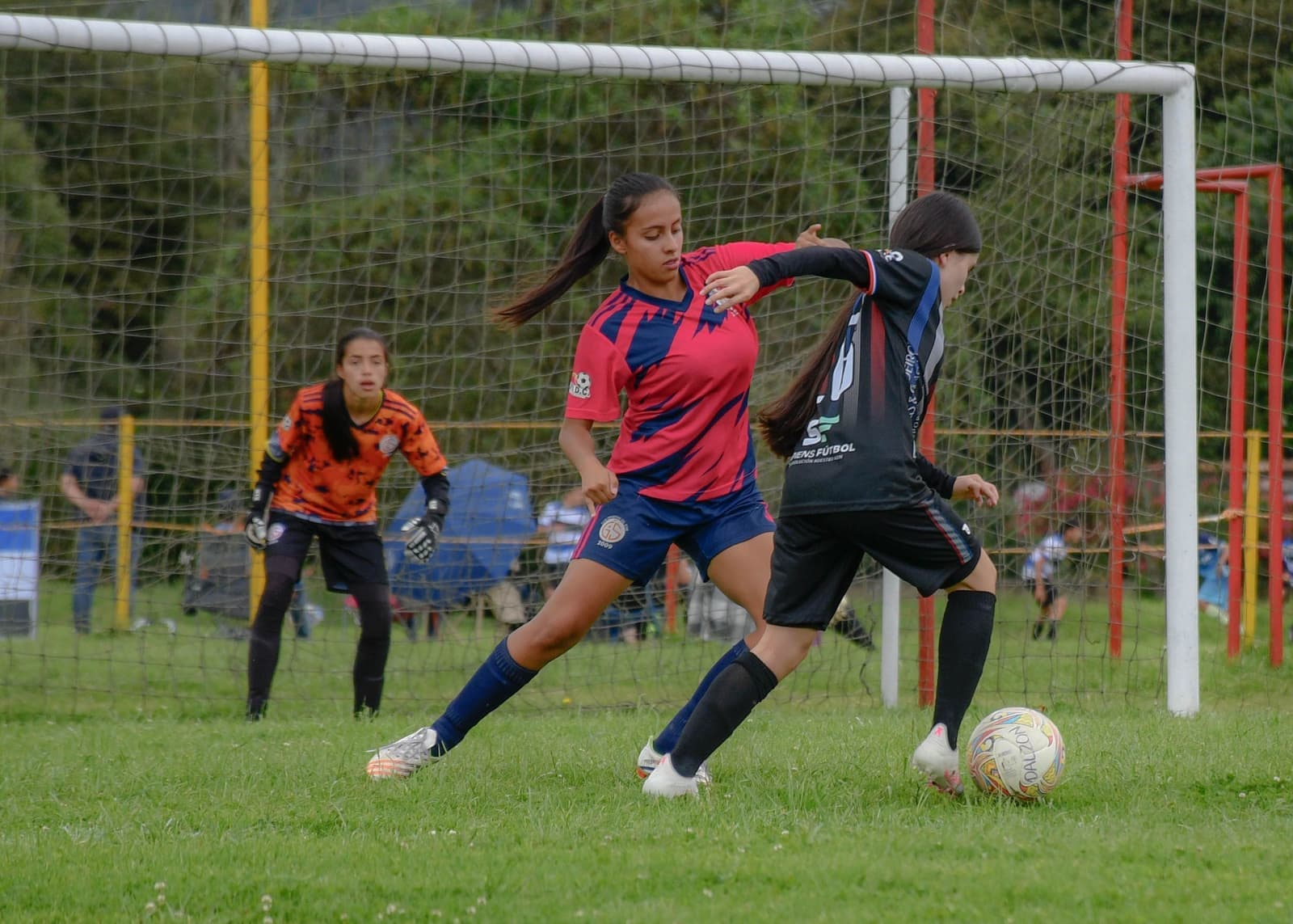 A young soccer player in a youth match on a grass field