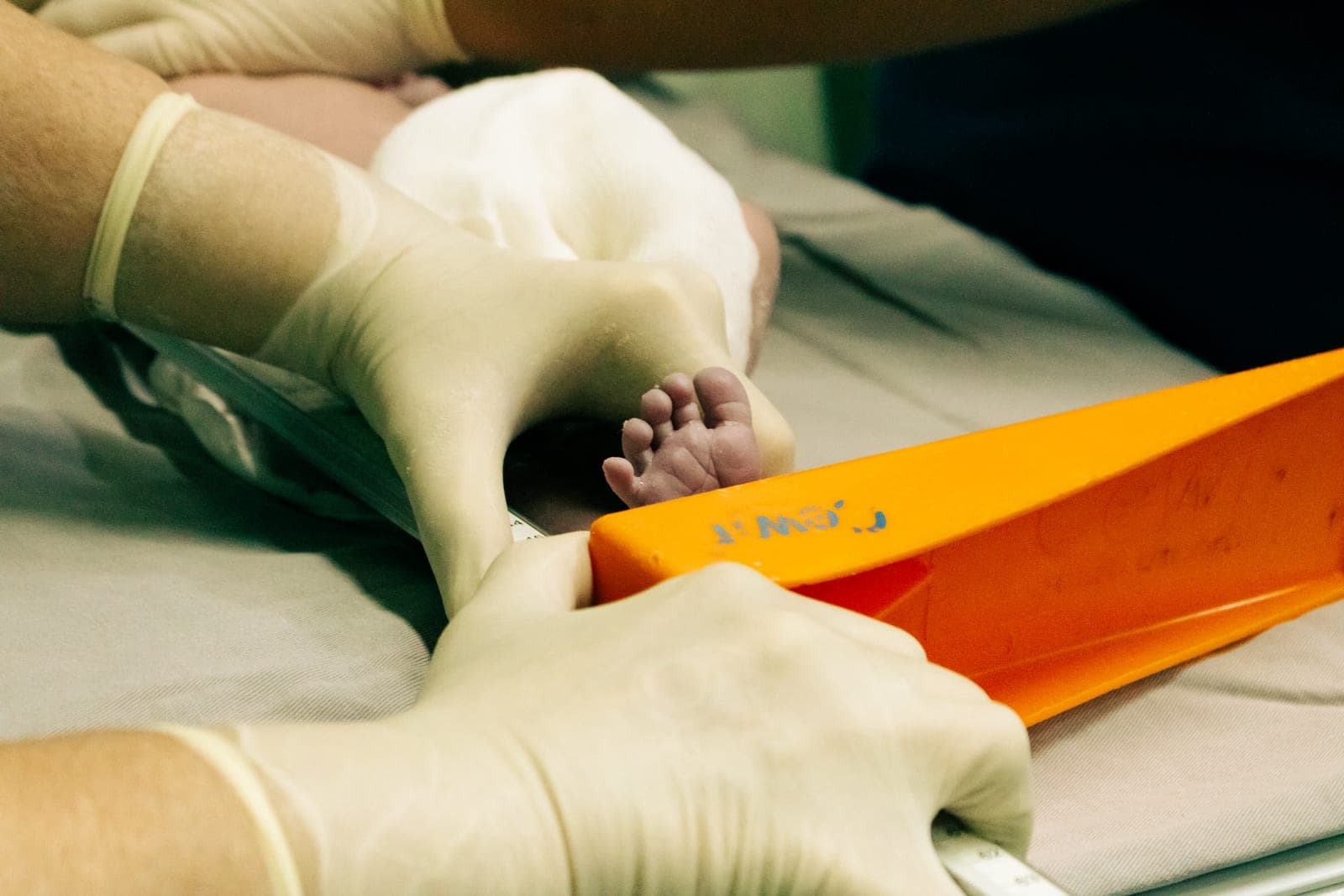 A child's foot being measured during a shoe fitting